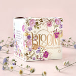 Bloom bath bomb with floral design on a pink background