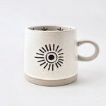 Ceramic mug with sun design on a white background