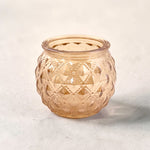Rose Gold Votive on a grey surface