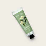Hand cream tube labeled 'Gardenia' from 'Flower Market' on a light background