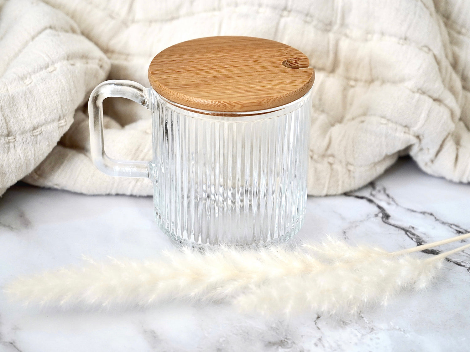 Ribbed clear glass mug shown with bamboo lid 12 oz capacity