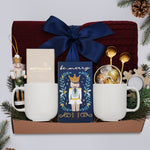 Wildflower Pop Holiday for Two Blanket Gift Box, with Burgundy cable knit blanket, chocolate bar, nutcracker ornament, drink sampler, truffle assortment, 2 gold demitasse spoons, 2 cream ceramic mugs, and snowflake votive