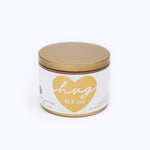 Wildflower Pop Candle jar with gold lid and 'hug in a jar' label on a white background