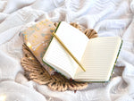 Floral embroidered notebook in your choice of either meadow green or cream. Comes with Gold Ballpoint Pen