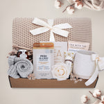 Oatmeal and Honey gift box with honeycomb blanket, tea sampler, pedi kit, grey cozy boot socks, mini honey and dipper, hand cream, and Wildflower Pop exclusive Farmhouse mug