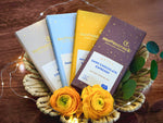 Moonstruck chocolate bars shown in milk chocolate, dark chocolate almond, milk chocolate toffee, and dark chocolate espresso
