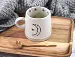 Moon and sun ceramic mug 12oz capacity shown with moon motif