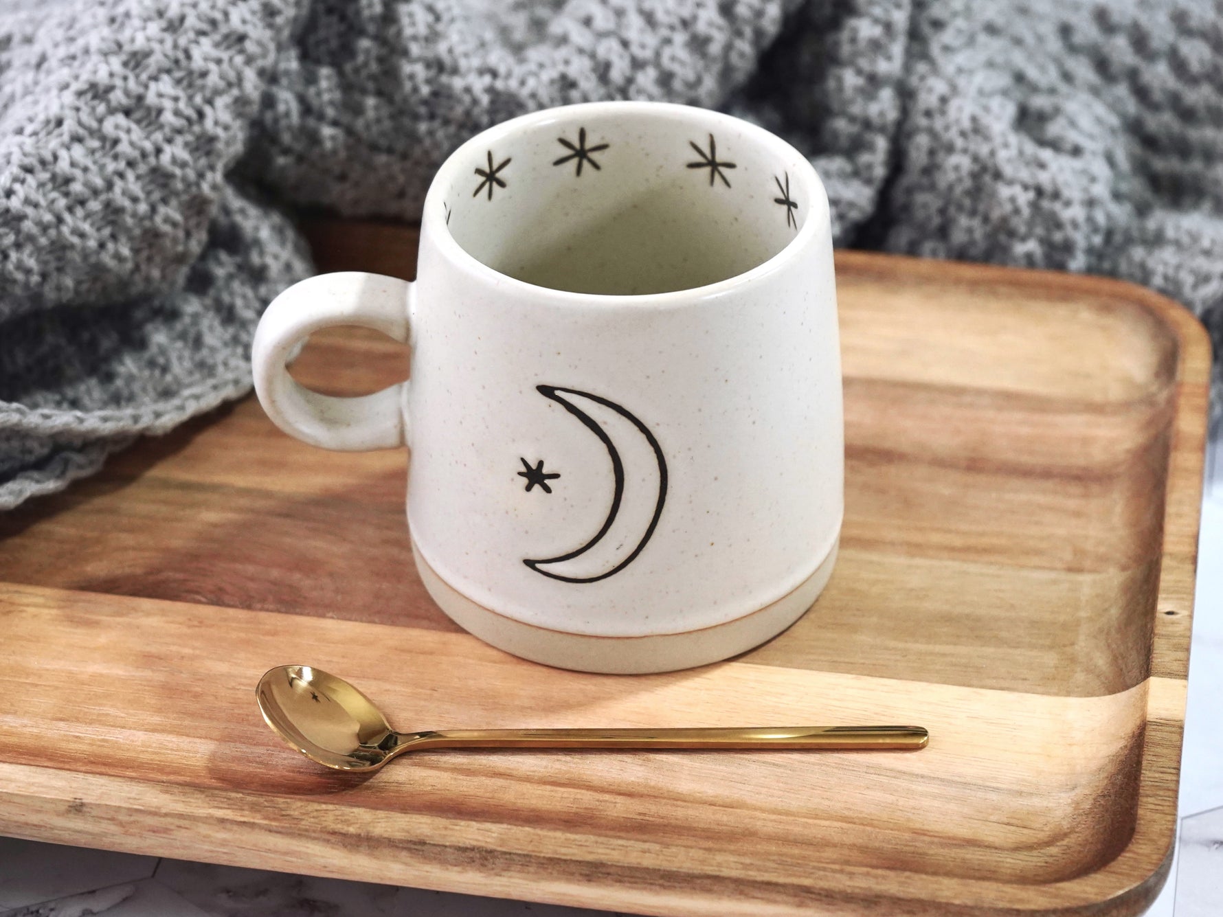 Moon and sun ceramic mug 12oz capacity shown with moon motif
