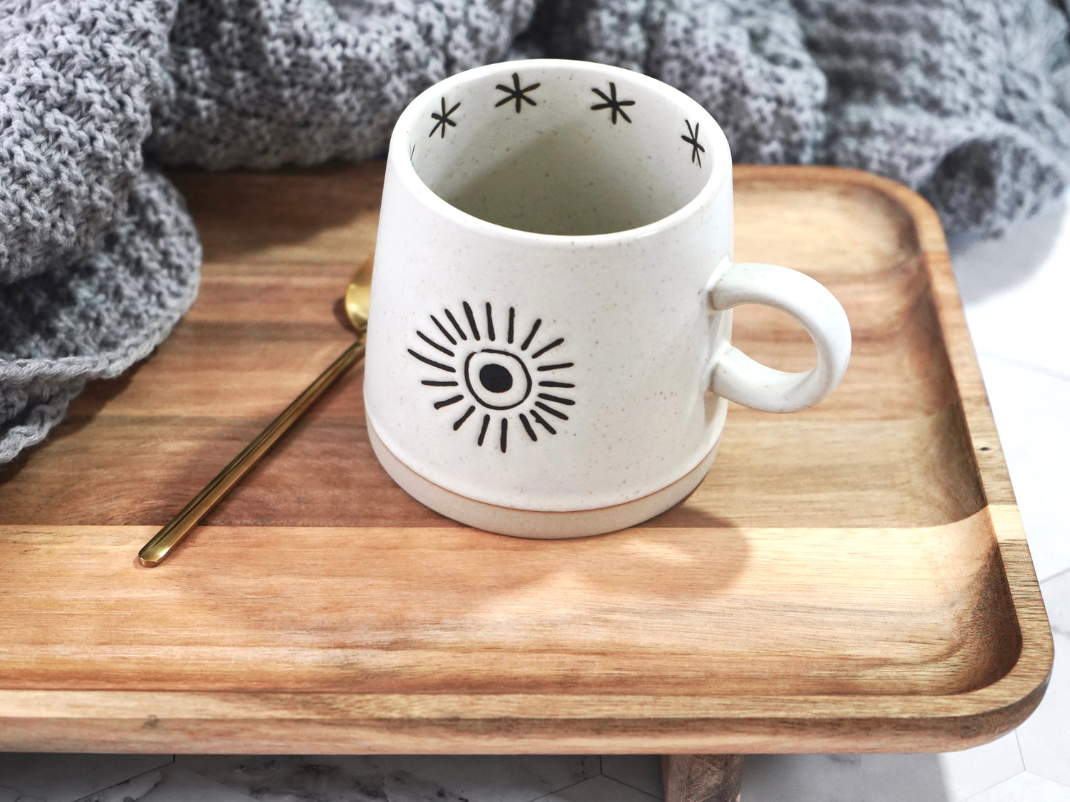 Moon and sun ceramic mug 12oz capacity shown with sun motif