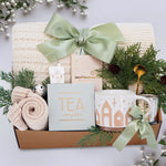 Wildflower Pop Holiday Gift basket with tea, mug, and decorative items on a light background