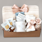 Gift basket with tea, cookies, and decorative items on a gray background