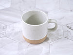 Speckled ceramic mug 12 oz capacity in cream color with black flecks clay bottom