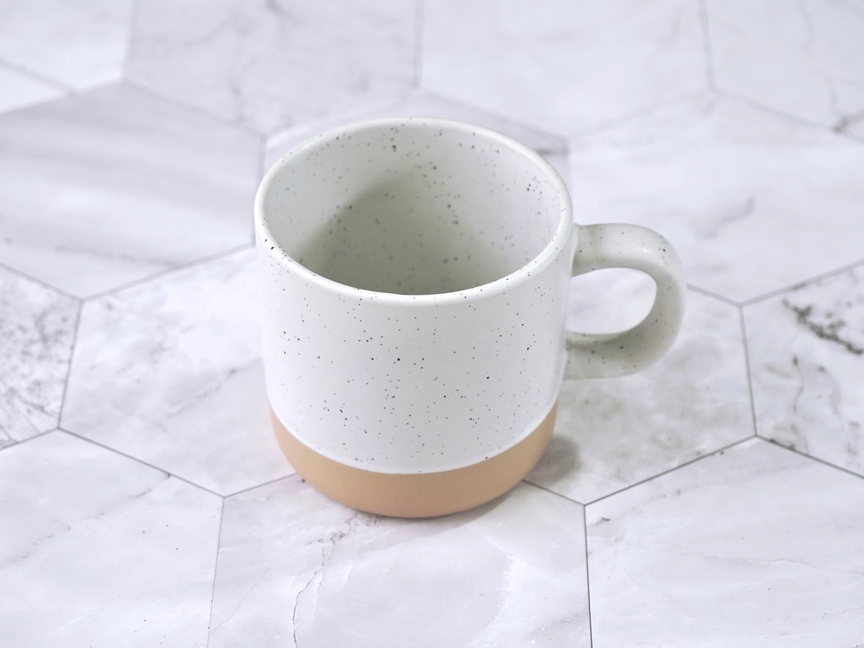 Speckled ceramic mug 12 oz capacity in cream color with black flecks clay bottom