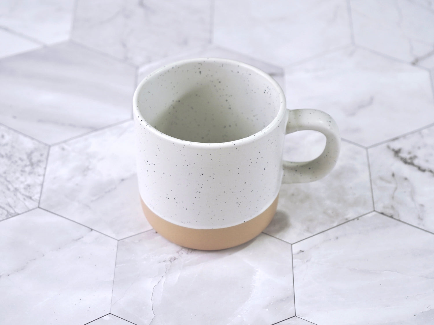 Speckled ceramic mug 12 oz capacity in cream color with black flecks clay bottom
