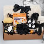 Wildflower Pop Halloween-themed boo basket with an exclusive ghost mug, candy, and decorative items on a white background.