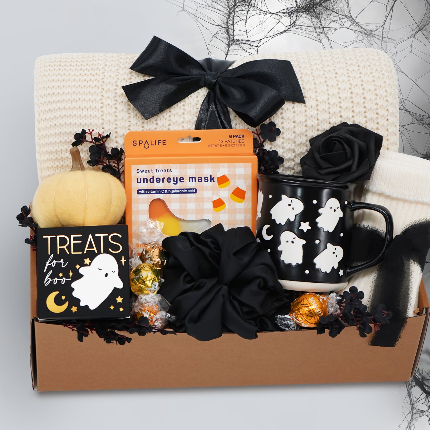 Wildflower Pop Halloween-themed boo basket with an exclusive ghost mug, candy, and decorative items on a white background.