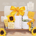 Wildflower Pop Sunny Days Ahead blanket gift box with a cream lace knit blanket, Wildflower Pop daisy ceramic mug, scallop trinket dish, moonstruck milk chocolate and toffee bar, little drop of sunshine bath bomb, faux sunflower, deep steep lotion, and cream knit socks