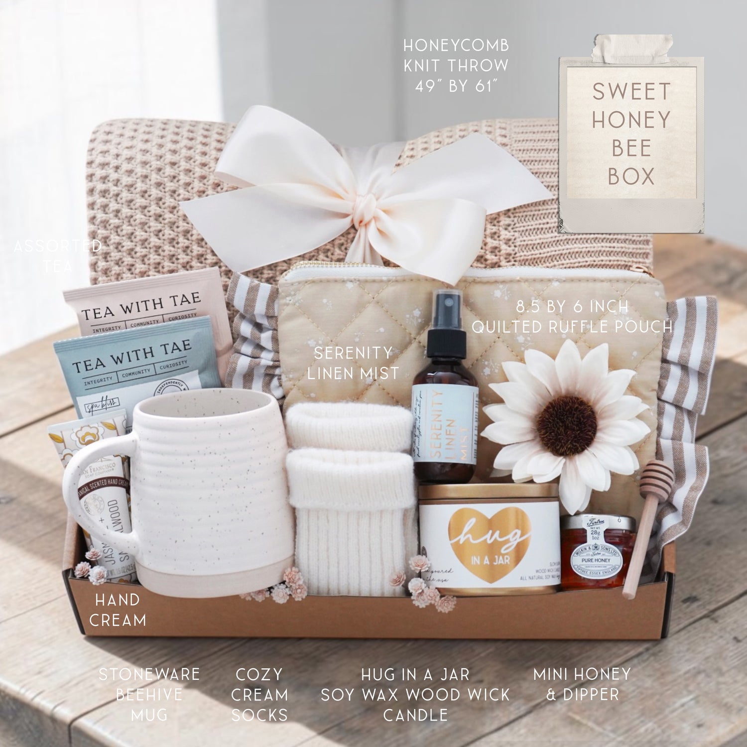 Sweet Honeybee luxury gift box featuring honeycomb knit blanket, candle, tea, mug, honey jar, socks, and self-care essentials