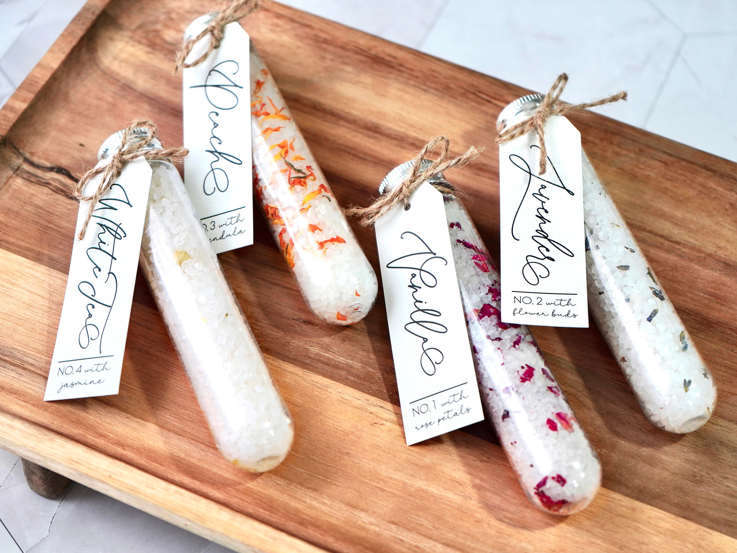 Floral Epsom Bath Salts Tube choose between vanilla with rose petals, peach with calendula petals, lavender with lavender buds, white tea with jasmine petals. Each tube is 2.8oz 