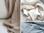 Wildflower Pop Knit Blankets Shown are in a close up are Tan Cable Knit, Cream lace knit and cornflower blue lace knit 