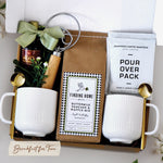 Breakfast for Two Gift Box for Couples includes 2 ceramic white ribbed mugs, 2 gold spoons, 1 dough whisk, 1 1.7oz maple syrup, 2 single serve coffee packs, and one 24oz pancake and waffle mix