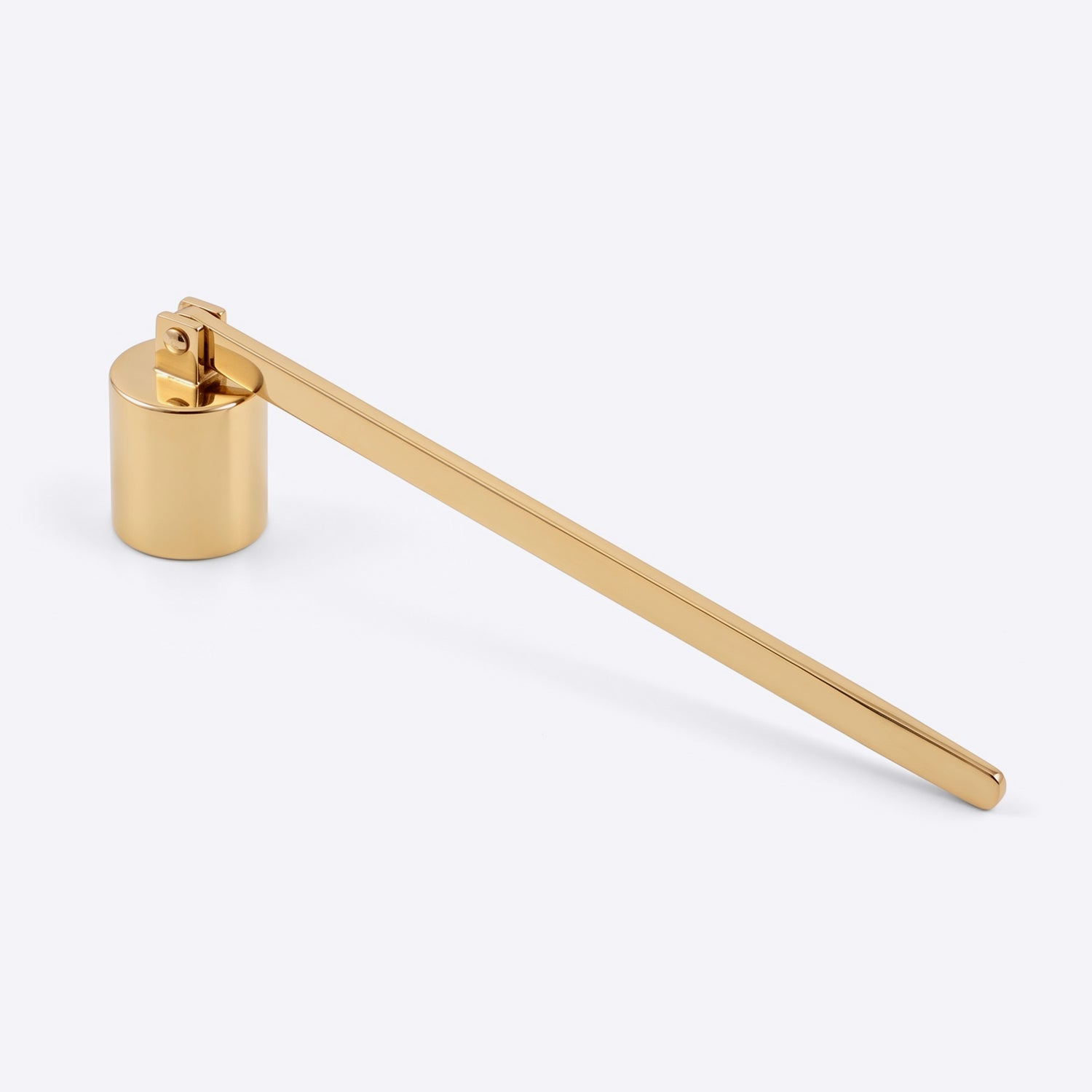 A modern, minimalist gold candle snuffer with a cylindrical base and a long, slender lever arm, shown on a clean light gray background.
