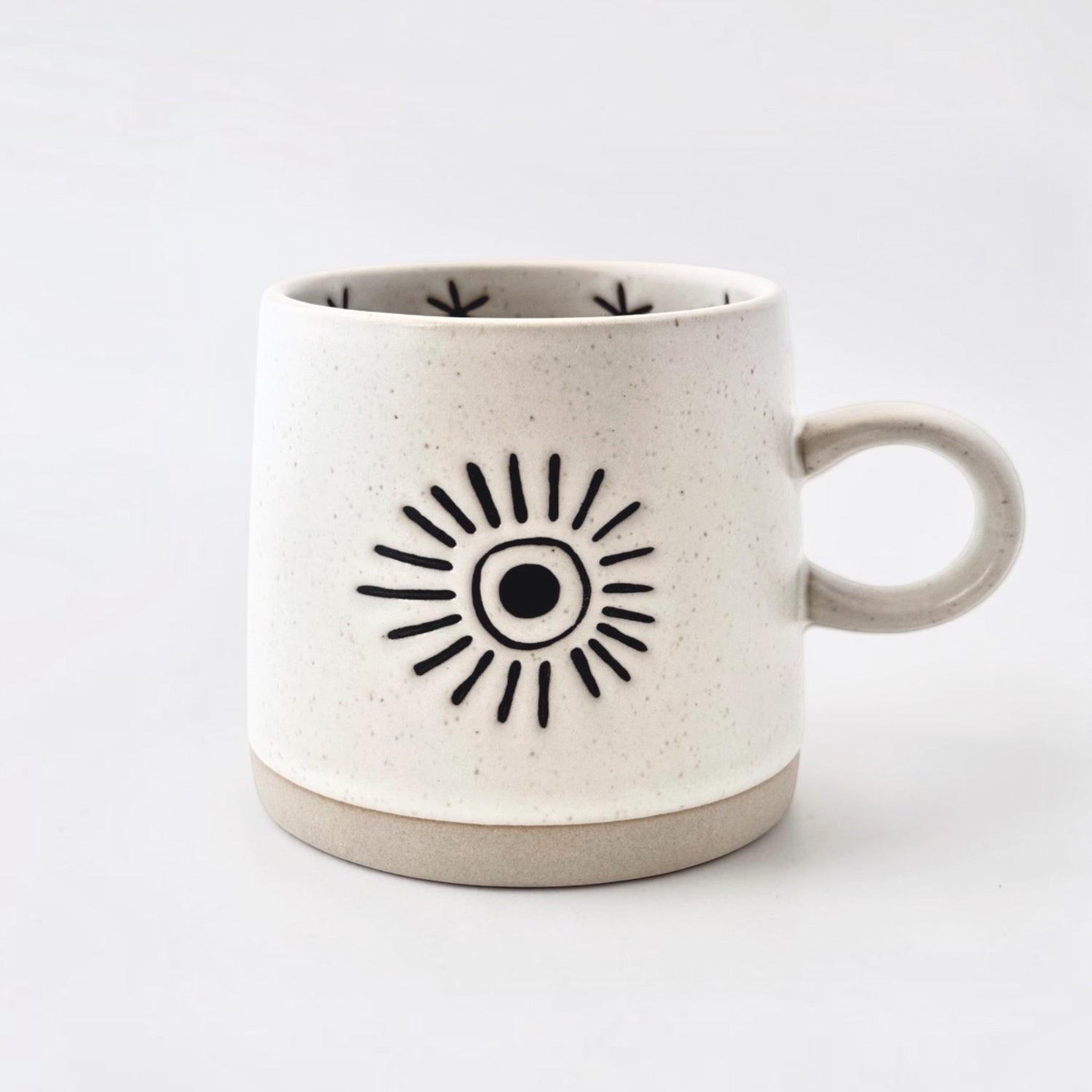 Ceramic mug with sun design on a white background