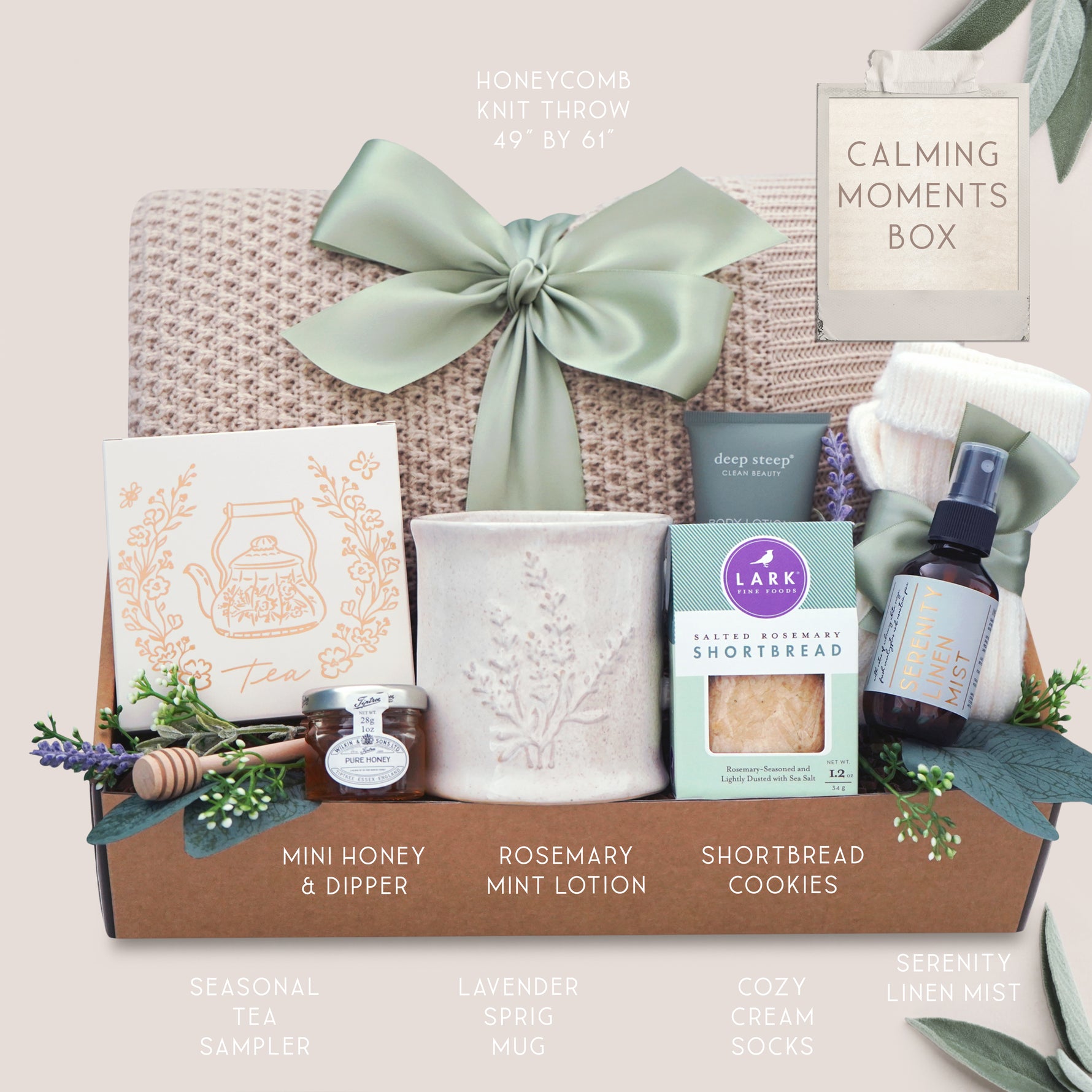 Gift box labeled 'Calming Moments Box' with various items including a honeycomb knit throw, tea, lotion, and cookies.