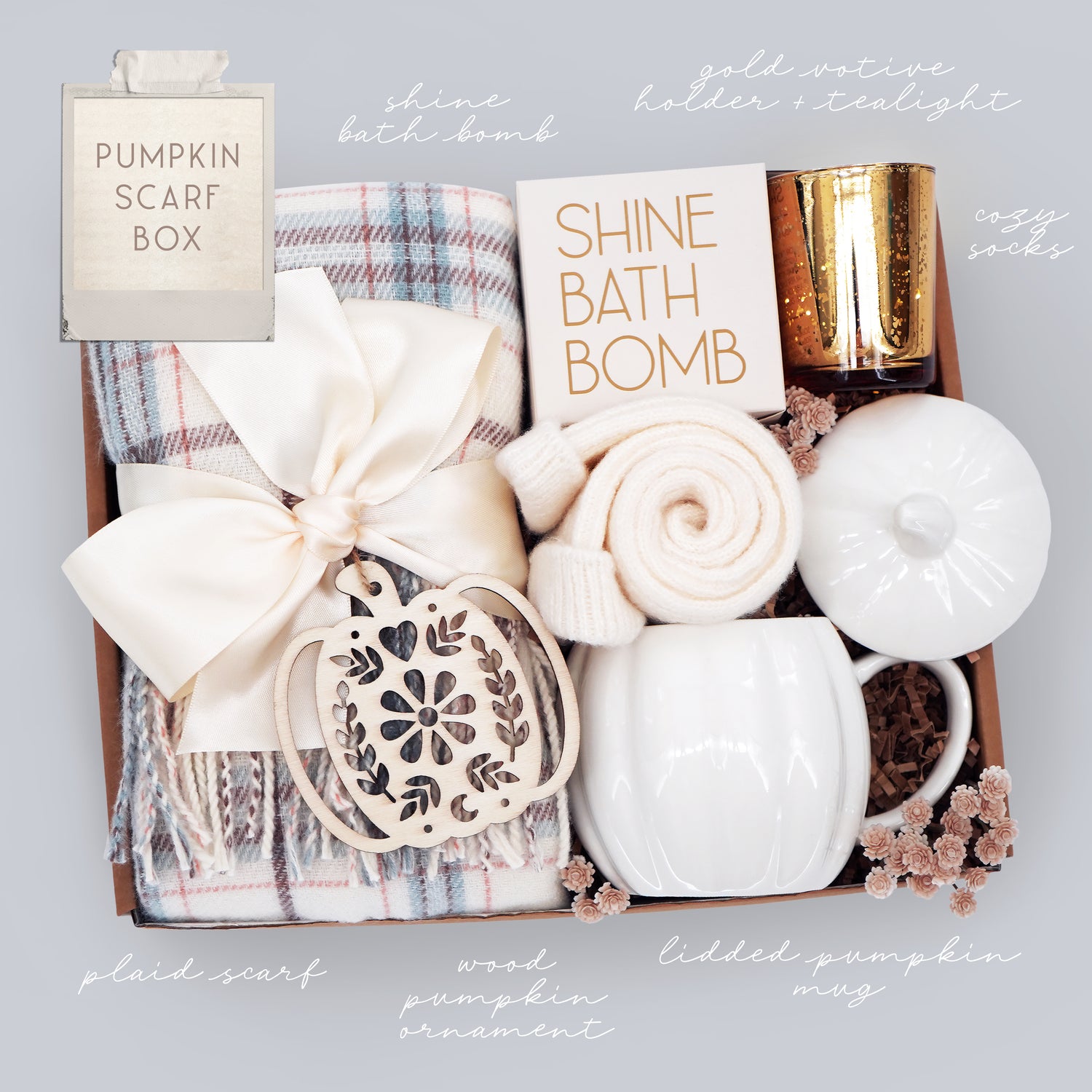 Pumpkin Scarf Box with bath bomb, candle, and other items on a light gray background