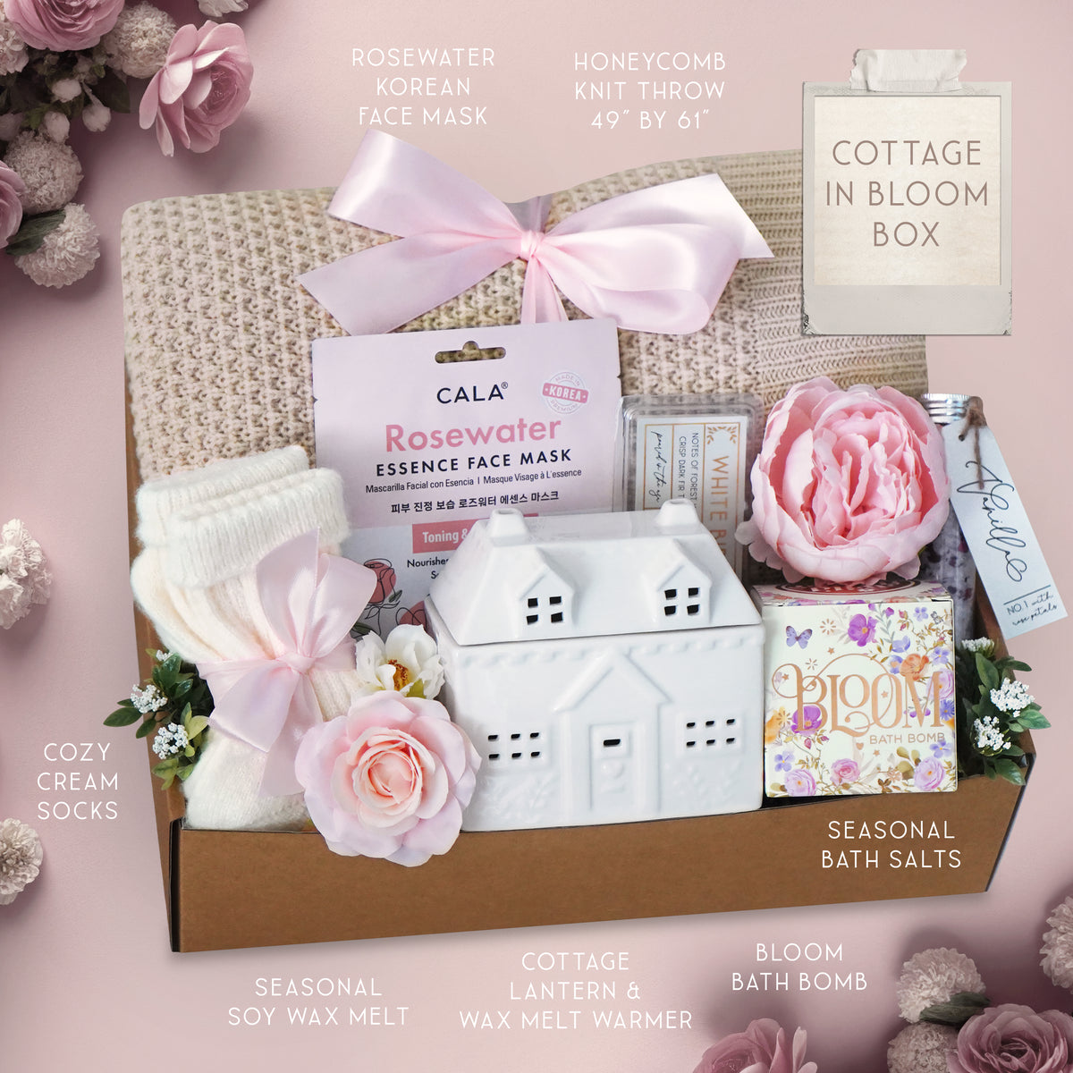 Cottage-themed gift box with various items on a pink background