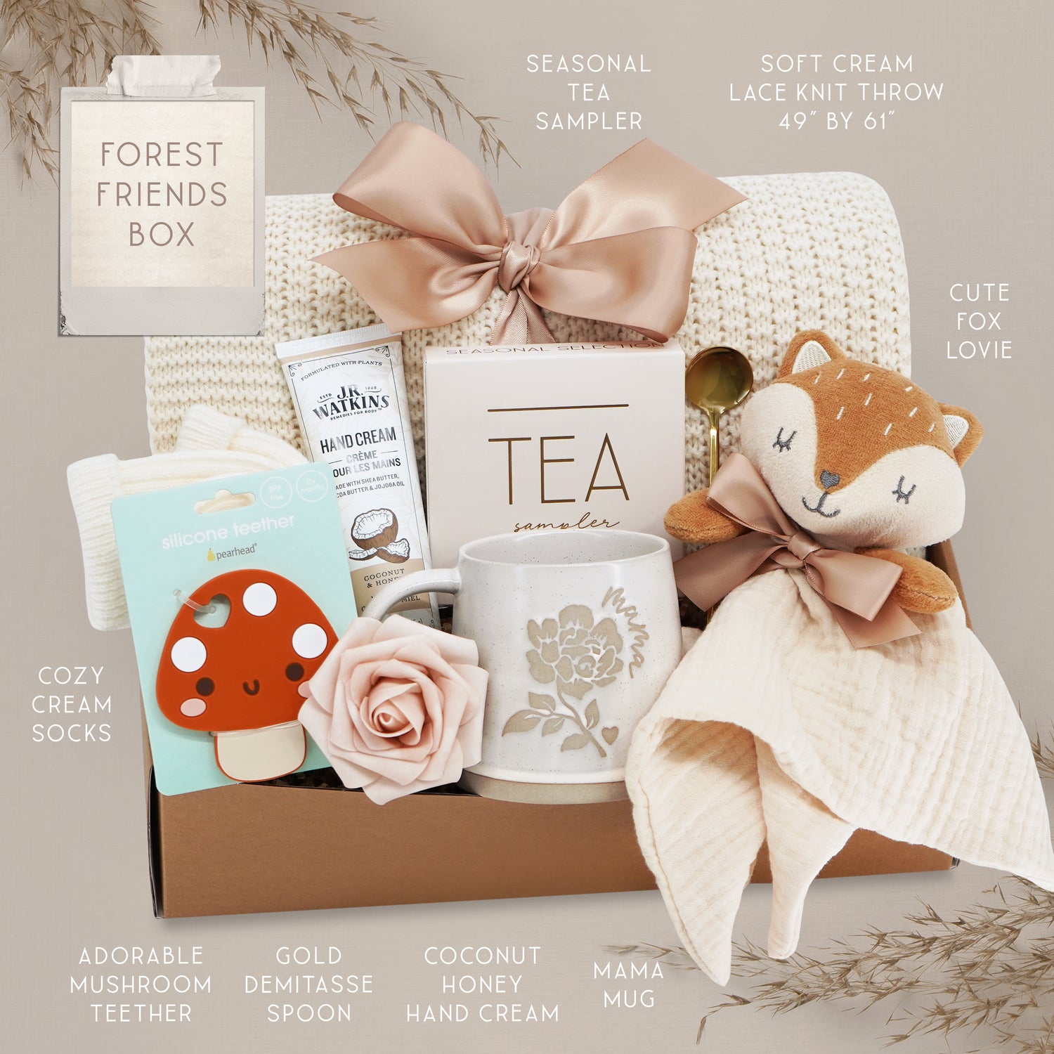 Gift box with various items including a mug, tea sampler, and fox plush toy on a neutral background.