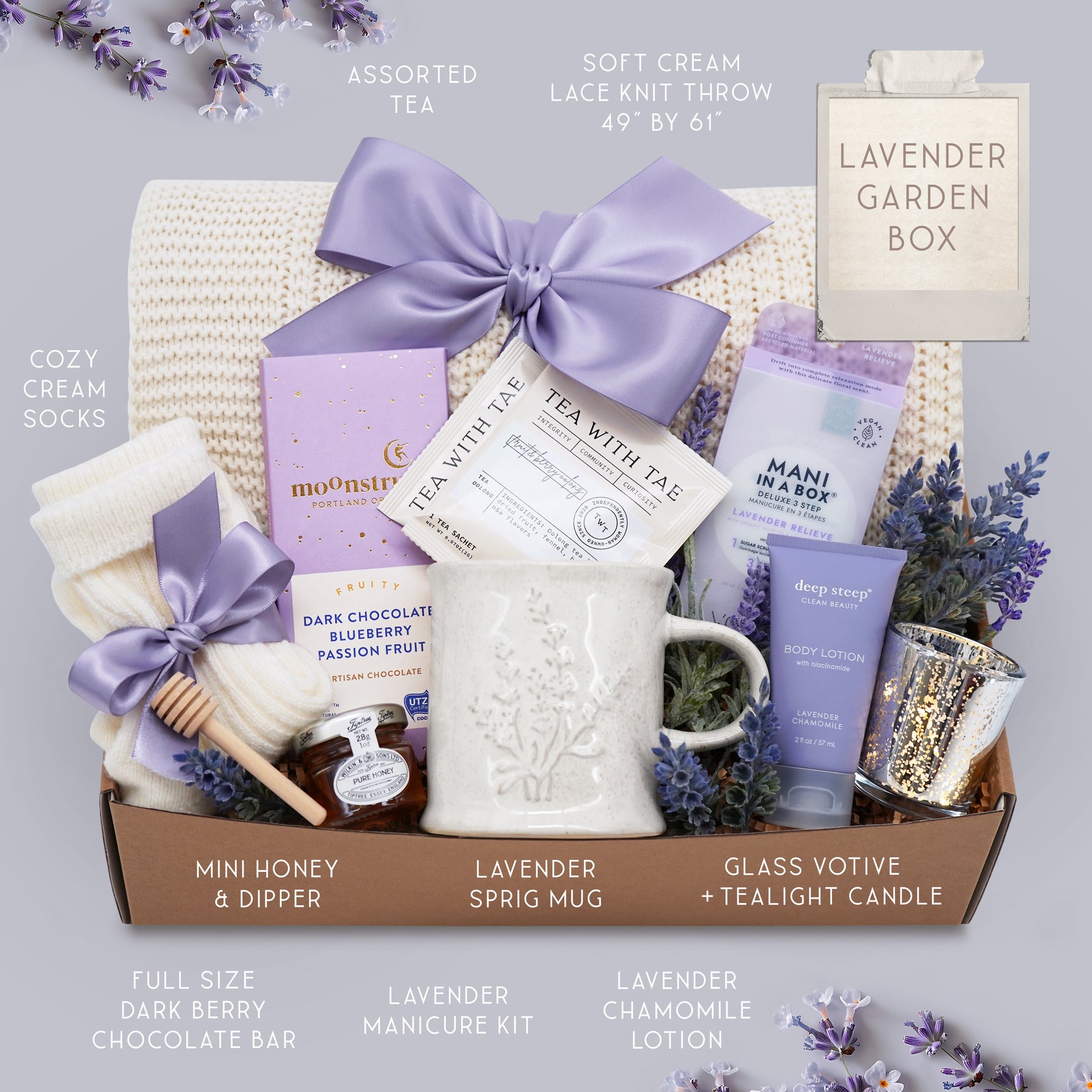 Lavender Garden blanket gift box by Wildflower Pop comes with cream lace knit blanket, mani kit, chocolate bar, cream knit socks, mini honey and dipper, Lavender Mug by Wildflower Pop, Lavender body lotion, silver votive with tea light