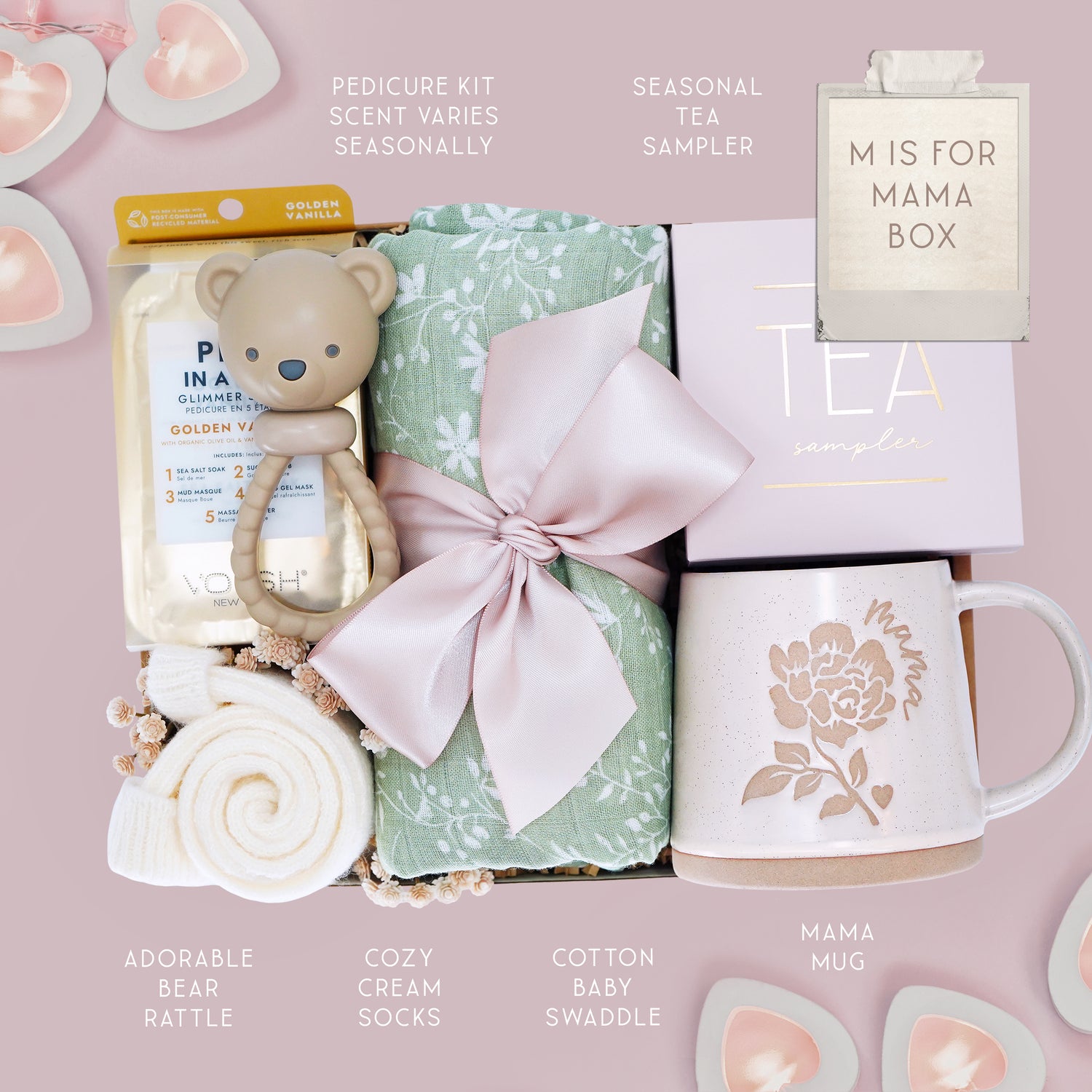 M is for Mama new mom gift set from Wildflower Pop comes with a sage green botanical swaddle, bear rattle, pedi kit, cream socks, tea sampler, and Wildflower Pop designed Peony Mama mug