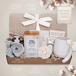 Oatmeal and Honey gift box with honeycomb blanket, tea sampler, pedi kit, grey cozy boot socks, mini honey and dipper, hand cream, and Wildflower Pop exclusive Farmhouse mug