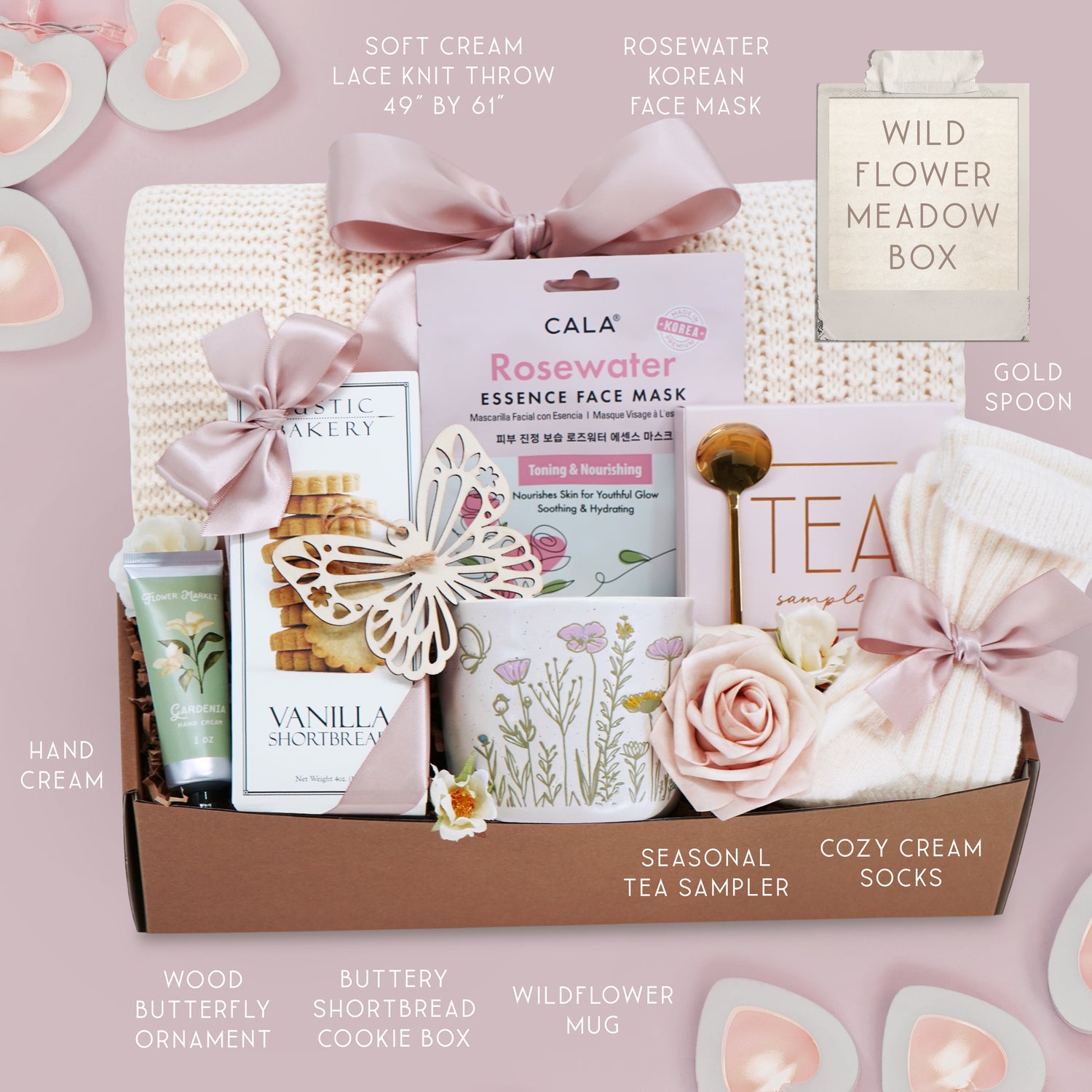 Wildflower Pop wildflower meadow blanket gift box with a cream lace knit blanket, Rosewater face mask, gold spoon, tea sampler, cream knit socks, faux rose, wildflower ceramic mug, wood butterfly ornament, Rustic bakery vanilla shortbread, Flower Market gardenia hand lotion 