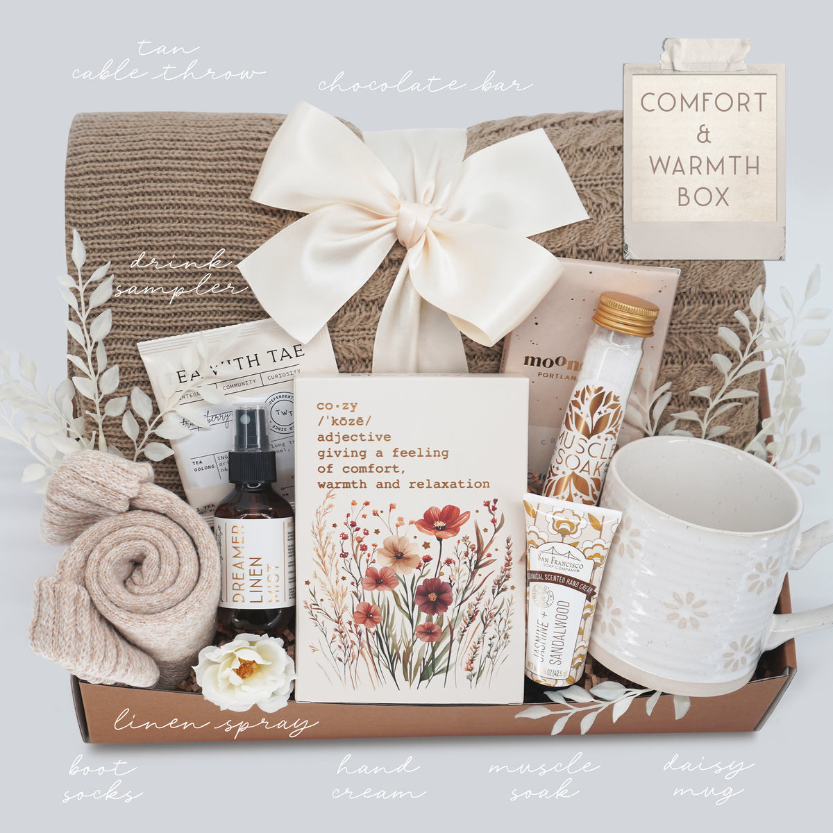 Wildflower Pop Gift box with various items including a mug, lotion, and a card, labeled 'Comfort & Warmth Box'.
