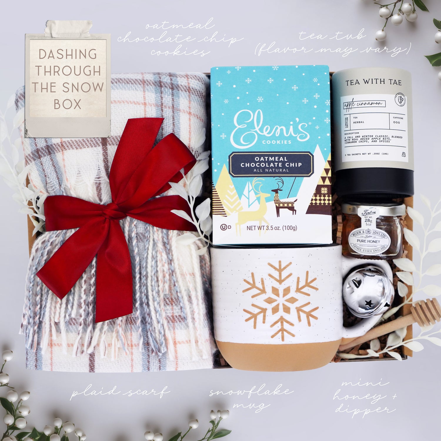 Wildflower Pop Holiday Gift set with plaid scarf, cookies, tea, and other items on a white background