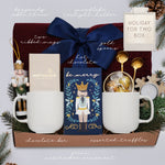 Wildflower Pop Holiday for Two Blanket Gift Box, with Burgundy cable knit blanket, chocolate bar, nutcracker ornament, drink sampler, truffle assortment, 2 gold demitasse spoons, 2 cream ceramic mugs, and snowflake votive 