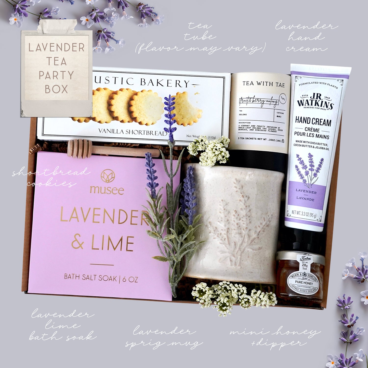 Lavender-themed gift box with cookies, soap, and other items on a light gray background.
