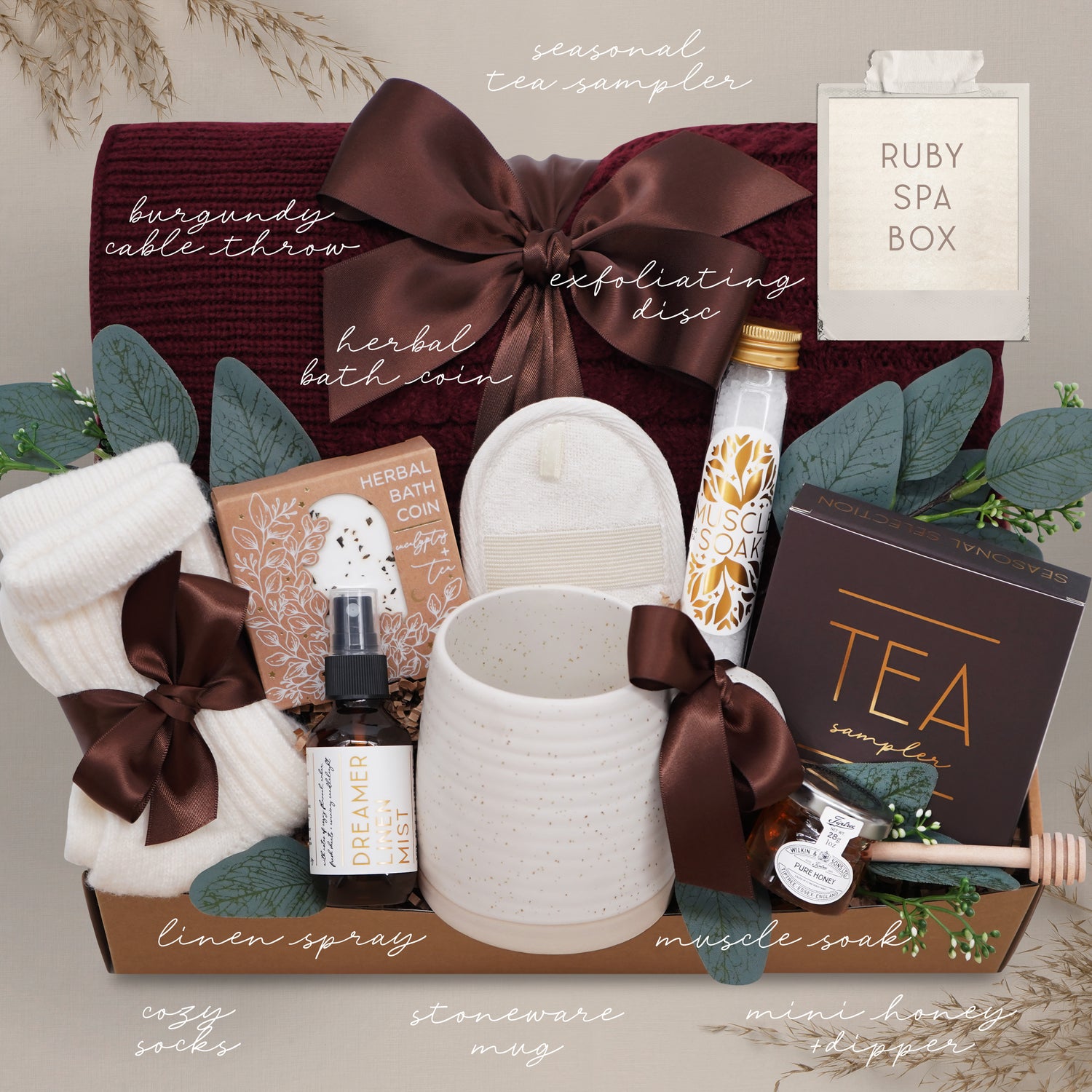 Ruby Spa Box with various items including a mug, soap, and tea packaging on a neutral background.