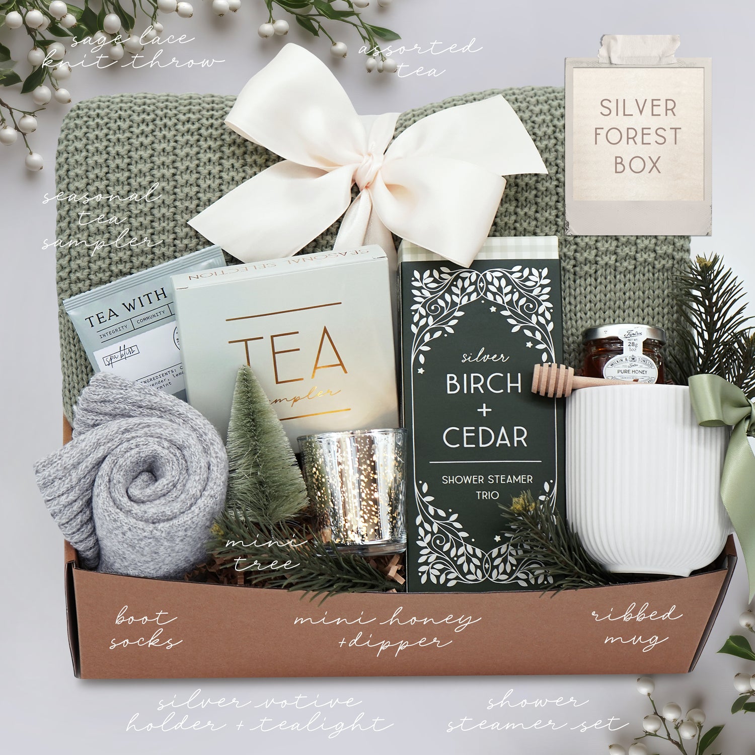 Gift box with tea, shower steamer, and other items on a white background
