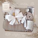 Wildflower Pop Cozy Cable Blanket Gift Box with tan cable knit blanket, Moonstruck Milk Chocolate, Floral bath salts, Lavender Sprig Mug, Cozy Boot socks, Tea, votive and Tea Light