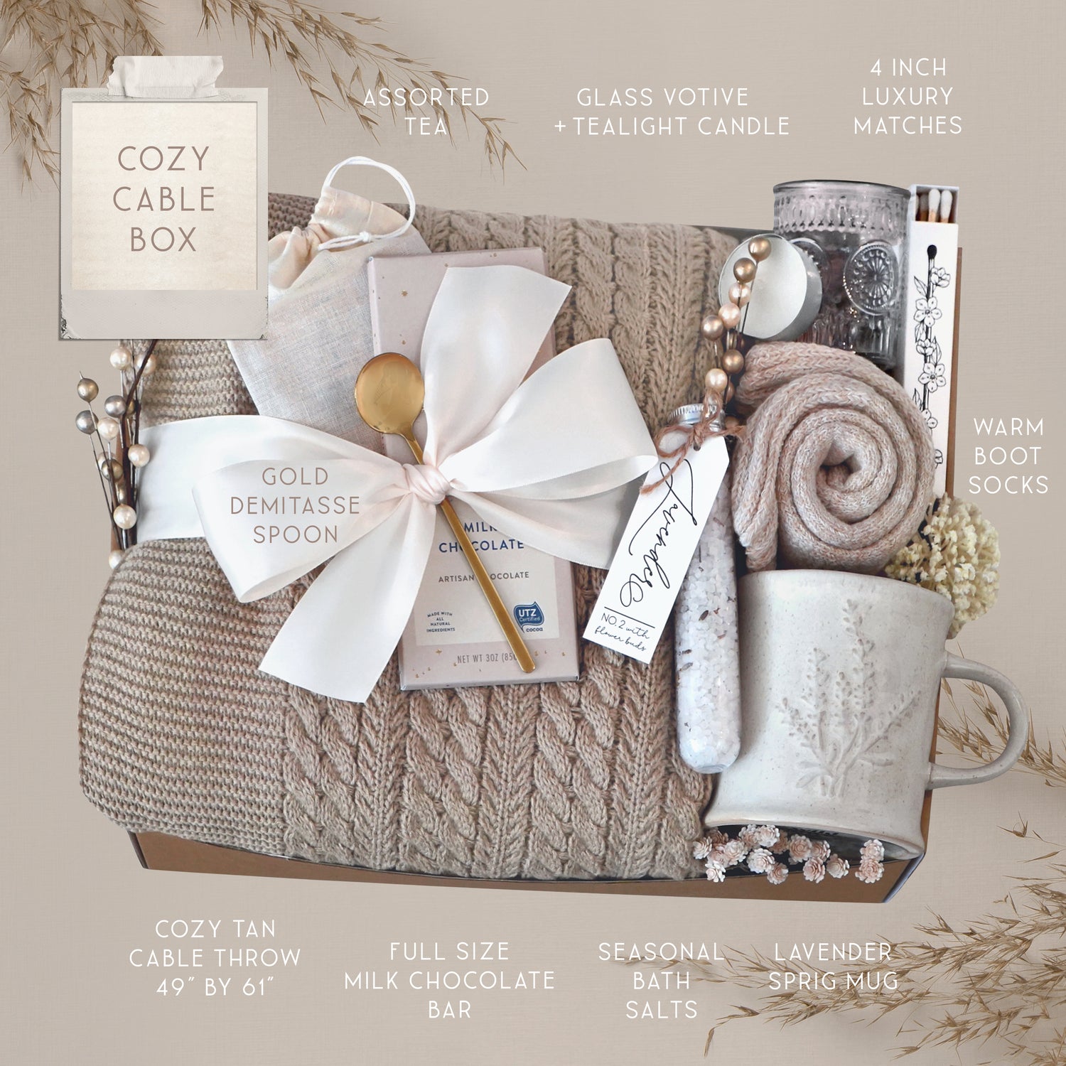 Wildflower Pop Cozy Cable Blanket Gift Box with tan cable knit blanket, Moonstruck Milk Chocolate, Floral bath salts, Lavender Sprig Mug, Cozy Boot socks, Tea, votive and Tea Light