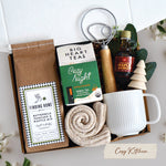 Cozy Kitchen Gift Box come with a ribbed white ceramic mug, dough whisk, 24oz pancake mix, cozy night tea bags 10 count, cozy boot socks, 1.7ox maple syrup, and faux eucalyptus sprig