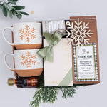Wildflower Pop Cozy Morning for Two Mug box with 2 snowflake mugs, mini maple syrup, hot chocolate sampler, tea with tae tea tube, pancake mix, and snowflake ornament