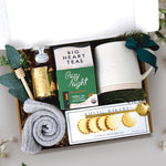 Cozy Night Gift Box comes with beehive ceramic mug, rustic bakery vanilla shortbread cookies, cozy night 10 count tea bags, mini honey and dipper, votive and tea light, and cozy socks
