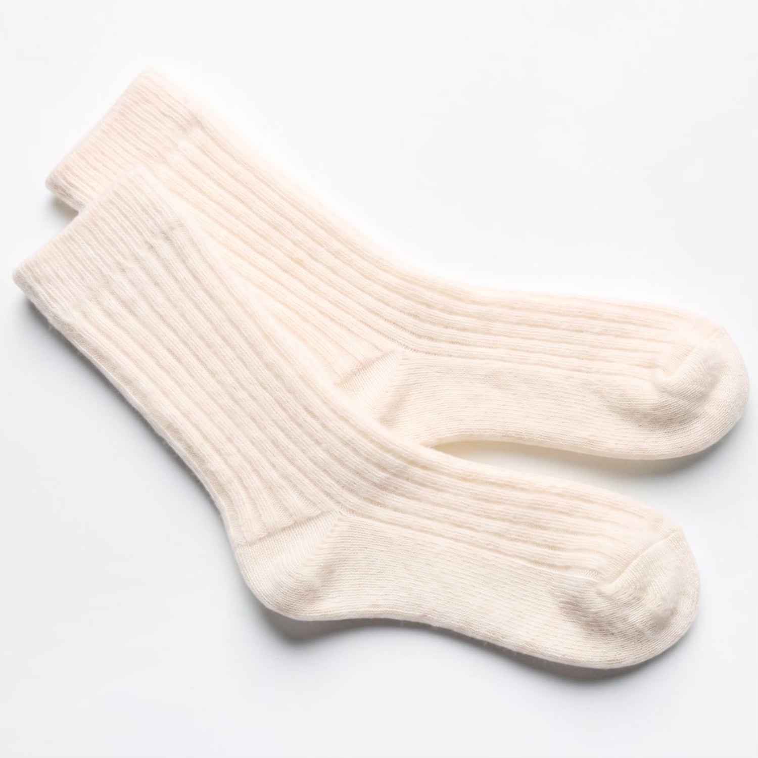 A pair of cream-colored ribbed crew socks laid flat on a clean white background.