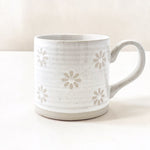 Wildflower Pop Exclusive Mug designed by us White ceramic mug with floral patterns on a white background