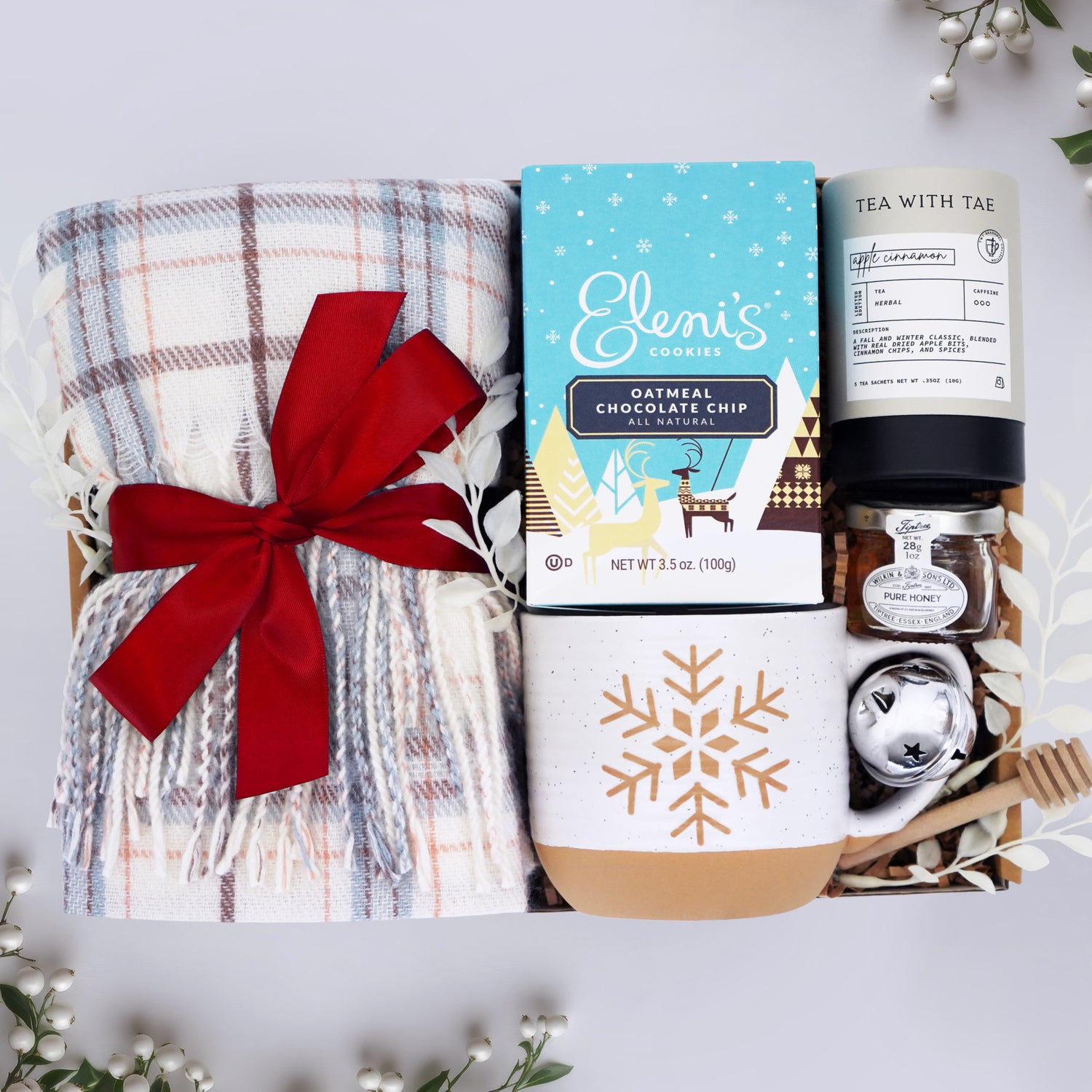 Wildflower Pop Holiday Gift set with plaid scarf, cookies, tea, and other items on a white background