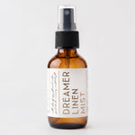 Travel size linen mist Dreamer scent on grey background.